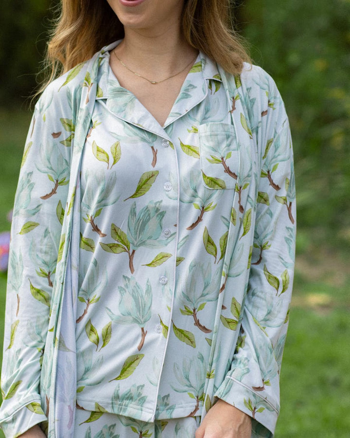 Light blue, short sleeve Audrey Pajamas top with green and brown leafy magnolia print. Available in sizes XS–XL.