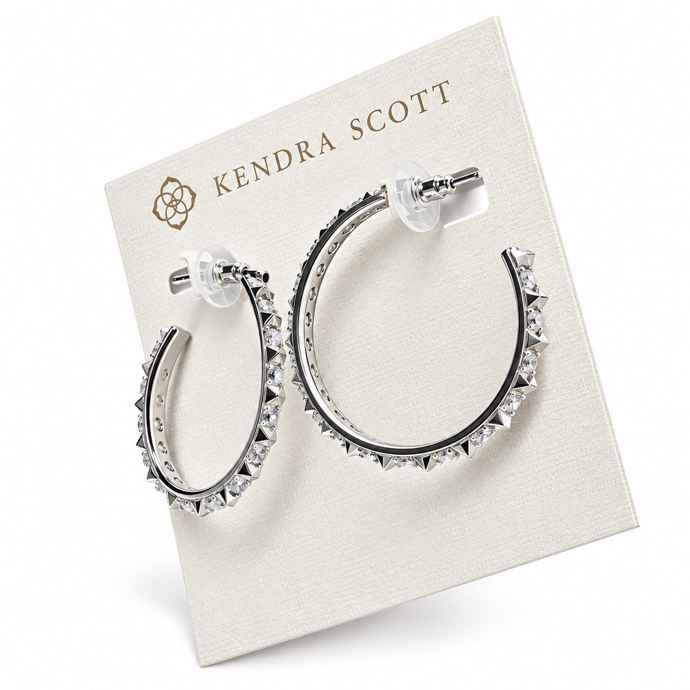 The Fate Hoop Rhodium White Cz earrings feature sleek sculptural spikes with small, pointed studs and transparent backings. Sizes available: Small, Medium, Large.