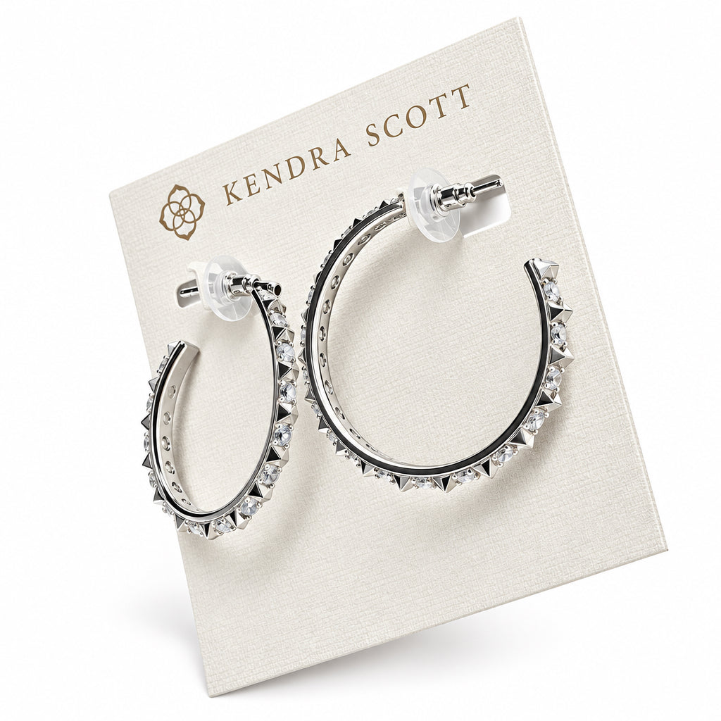 The Fate Hoop Rhodium White Cz earrings feature sleek sculptural spikes with small, pointed studs and transparent backings. Sizes available: Small, Medium, Large.
