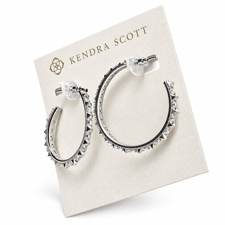 The Fate Hoop Rhodium White Cz earrings feature sleek sculptural spikes with small, pointed studs and transparent backings. Sizes available: Small, Medium, Large.