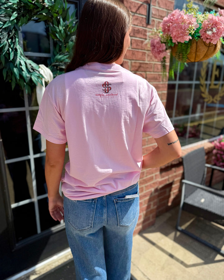 Light pink Y’all Are Nuts Tee with small festive logo on back. Available in sizes S-XXL.