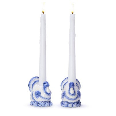 Blue and white hand-painted turkey candleholders holding two white taper candles. Sizes available: standard taper.