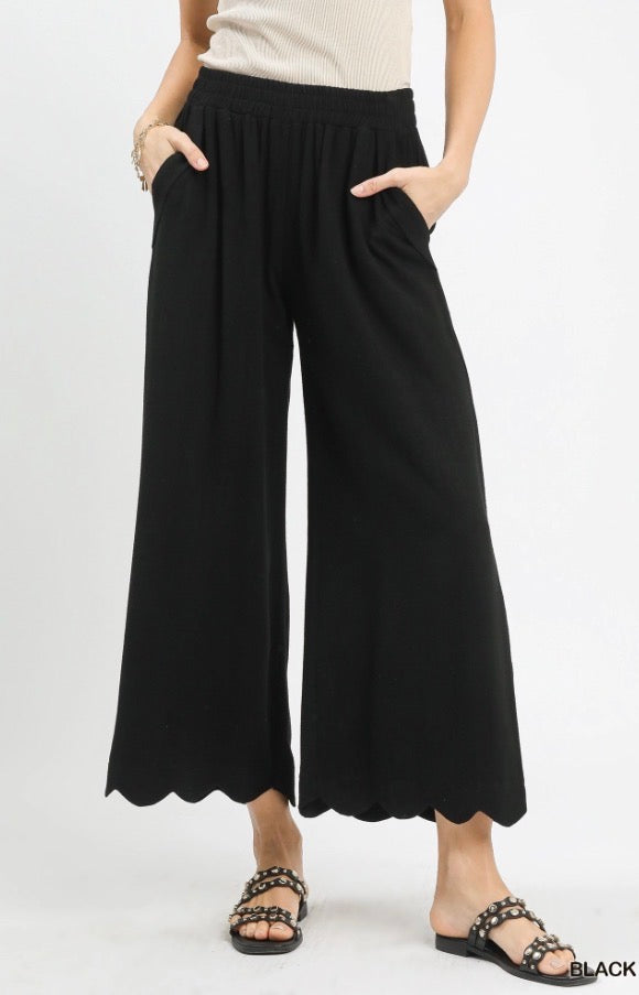 Scallop Wide Leg Pants in black linen blend with cropped scalloped hem and elastic waistband. Available in sizes XS-XL.