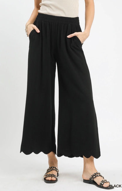Scallop Wide Leg Pants in black linen blend with cropped scalloped hem and elastic waistband. Available in sizes XS-XL.