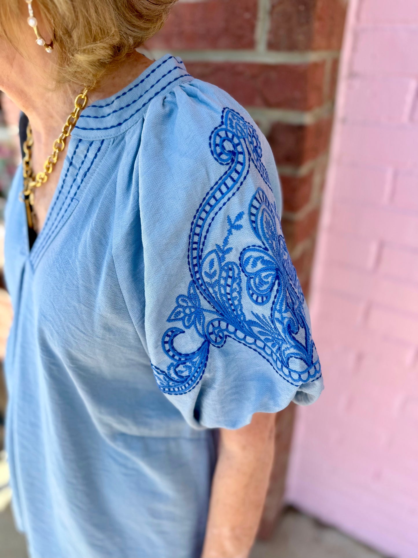 Light Blue Embroidered Puff Sleeve Top with detailed blue stitching on puff sleeves; available in sizes XS–XL.