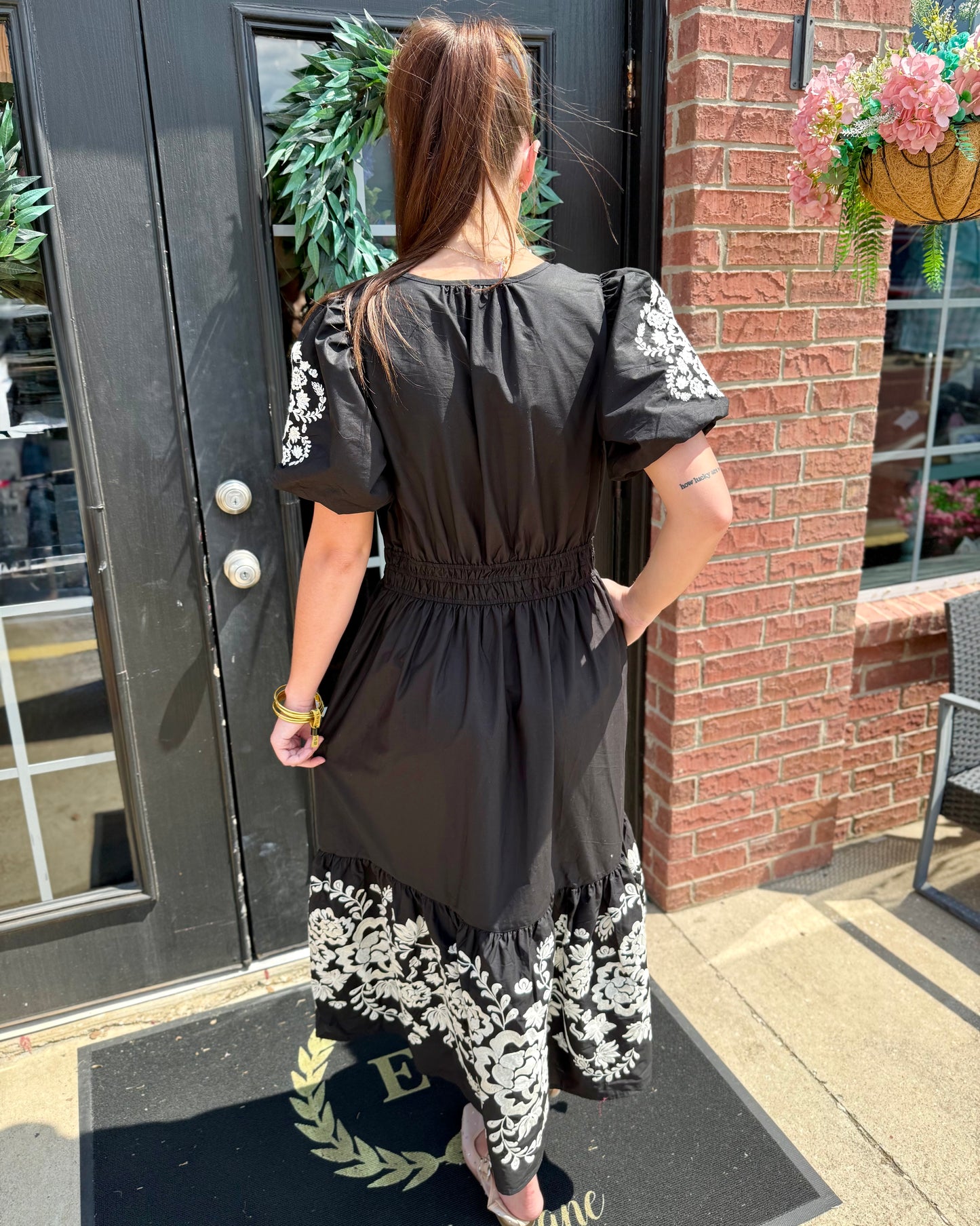 Tracey Aven Vines Black Dress featuring embroidery and a smocked waist, available in sizes XS-XL.
