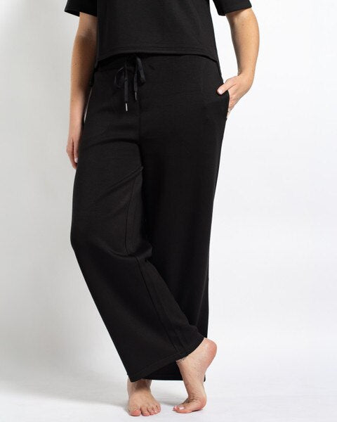 Taylor Pants: Black wide-leg lounge pants, relaxed fit, elastic drawstring waistband, side pockets. Sizes available.