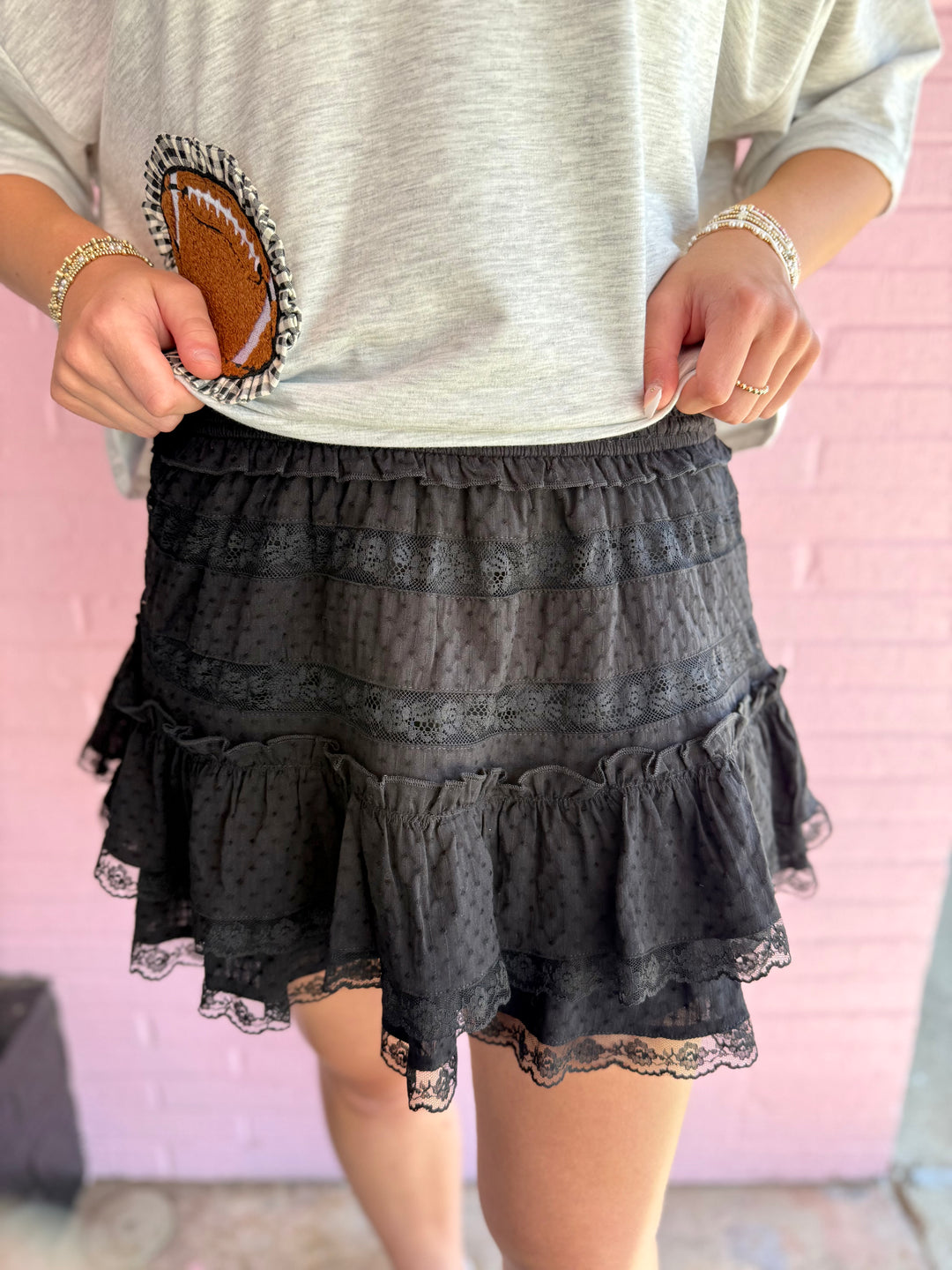 Emerson Black Lace Mini Skirt with scalloped lace detailing and elastic waistband, available in sizes XS–L.