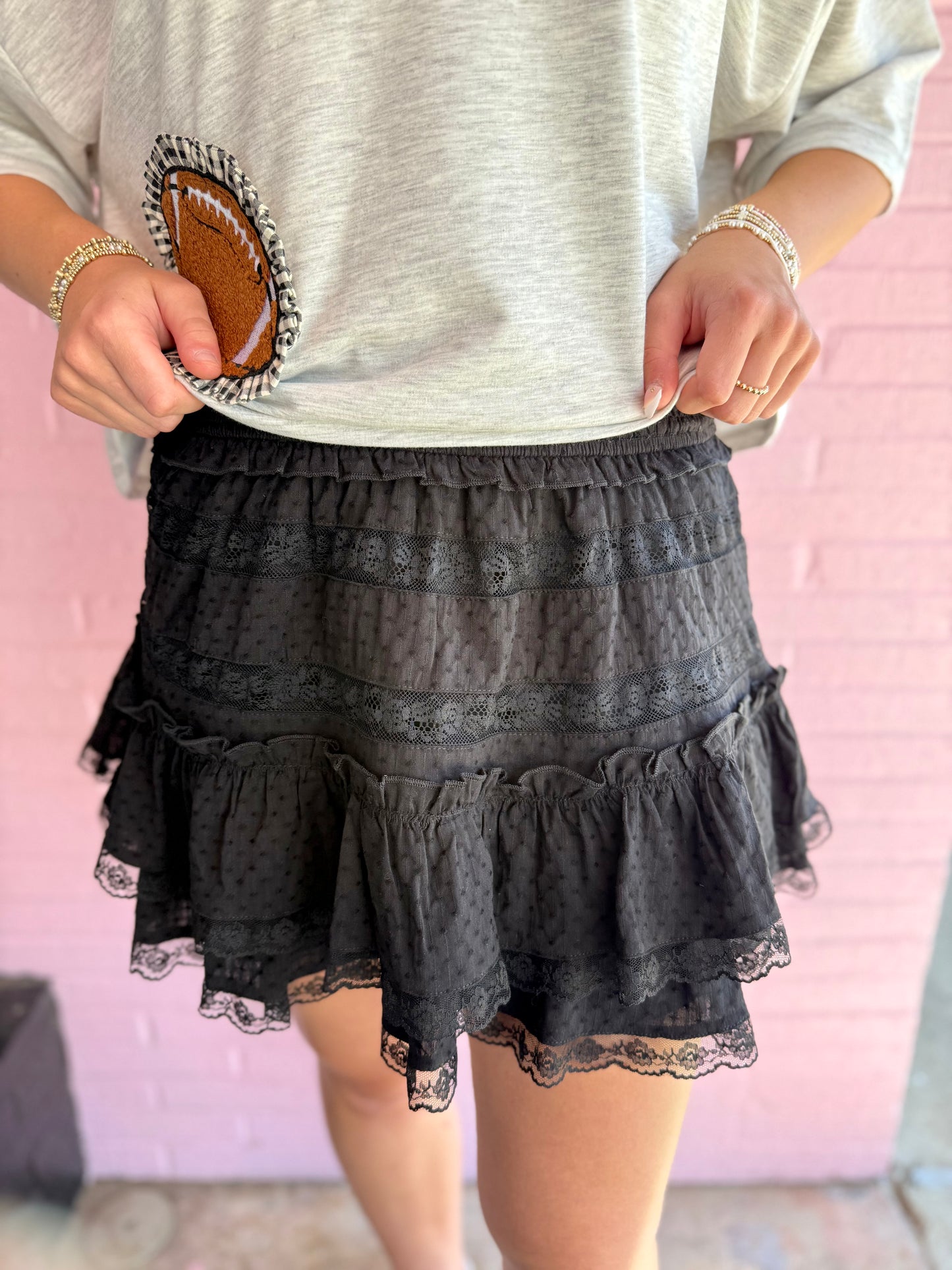 Emerson Black Lace Mini Skirt with scalloped lace detailing and elastic waistband, available in sizes XS–L.