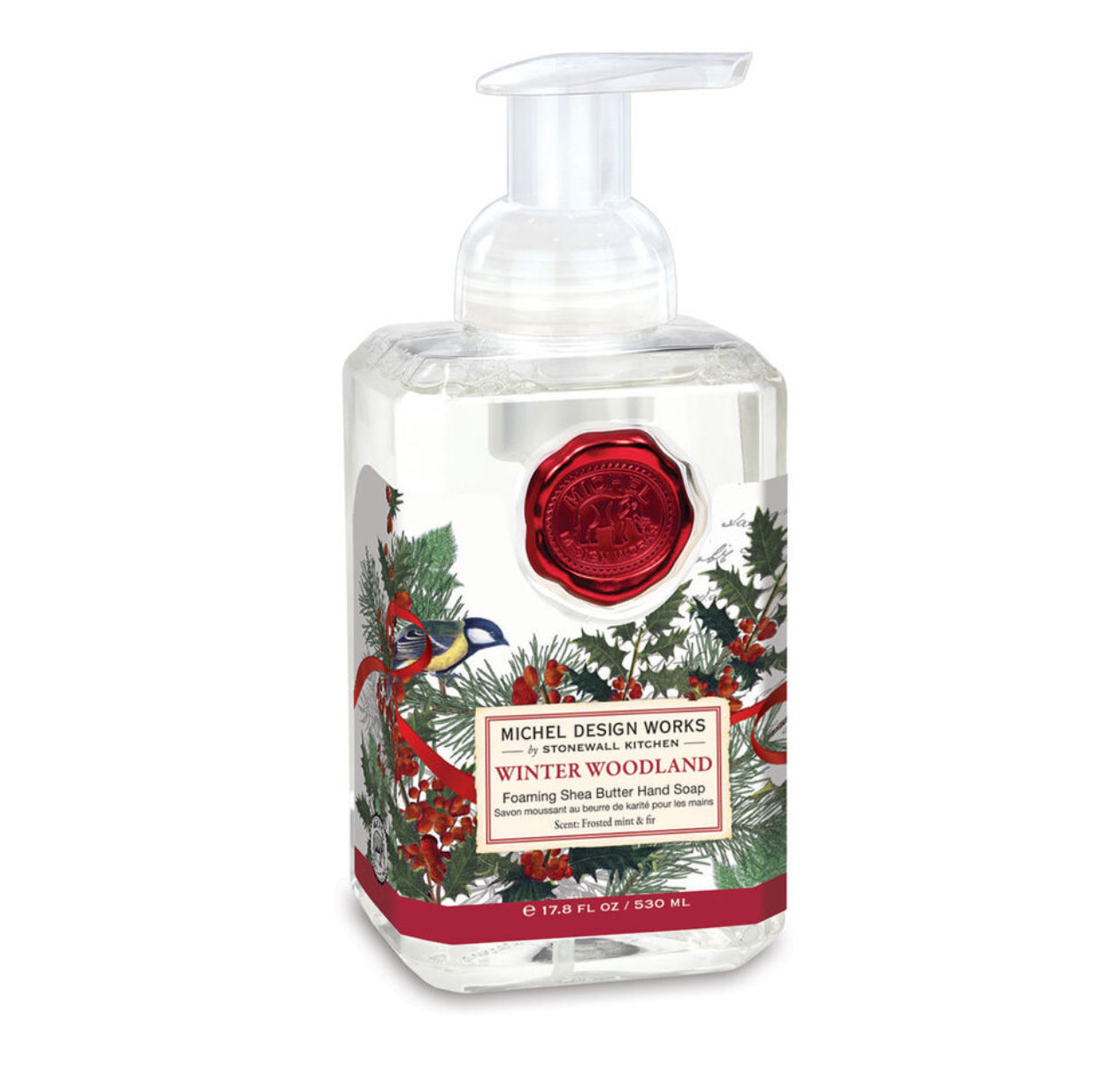 Clear pump bottle of Winter Woodland Foaming Soap by Michel Design Works. Features a red wax seal design, illustrations of birds, pine cones, and holly. Infused with aloe vera. 530 ml (17.8 fl oz).