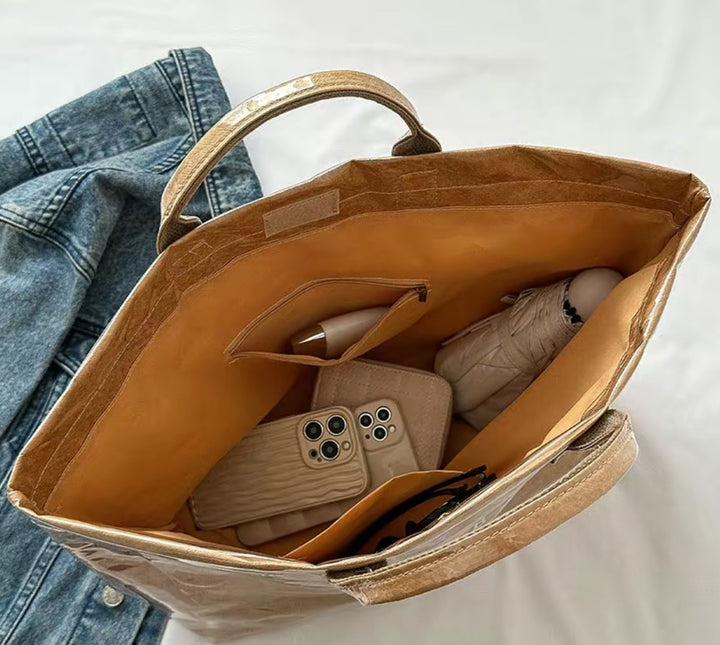 The Vintage Tote Bag with brown interior holds daily essentials. Available in small, medium, and large sizes.