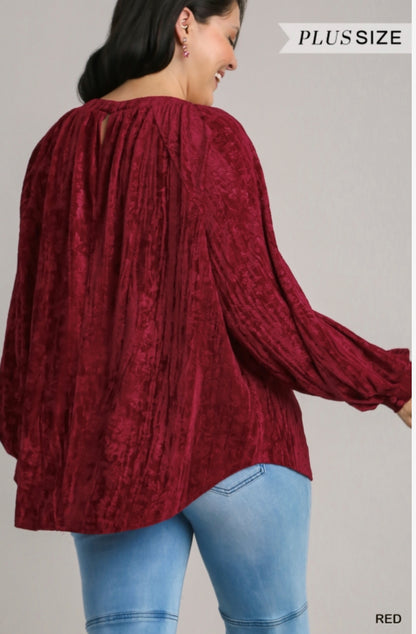 This Velvet High Low Long Sleeve Top is available in plus size. It is a bold red top with long sleeves, featuring a high low design.