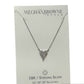 This product is an 18K / Sterling Silver Heart Drop Necklace, characterized by a silver chain and a triangular pendant. The pendant is adorned with many small, sparkling stones. The necklace comes on a white card with text included. Available in one standard size for all.