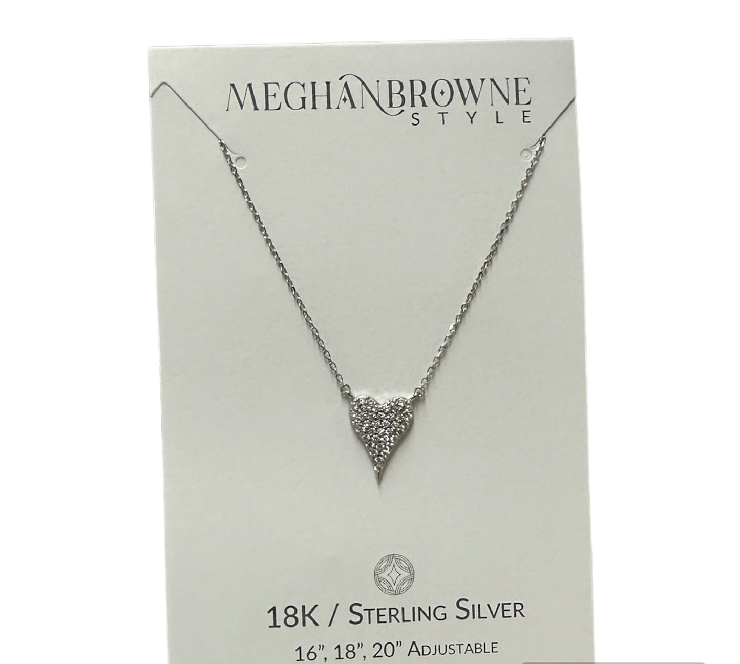 This product is an 18K / Sterling Silver Heart Drop Necklace, characterized by a silver chain and a triangular pendant. The pendant is adorned with many small, sparkling stones. The necklace comes on a white card with text included. Available in one standard size for all.