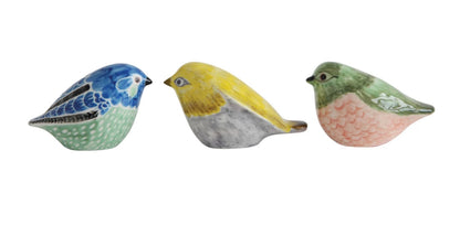 Hand-painted stoneware birds in blue, yellow, or green-pink with distinct patterns. Available in small, medium, and large sizes.