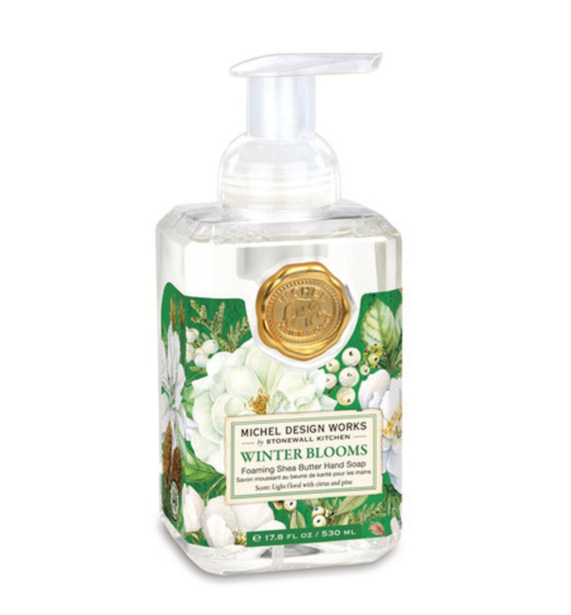 Winter Blooms Foaming Hand Soap by Michel Design Works. Features a white pump top and floral artwork with green leaves and white magnolia flowers. Scent: snow, light florals, vetiver. Size available: 17.8 fl. oz.