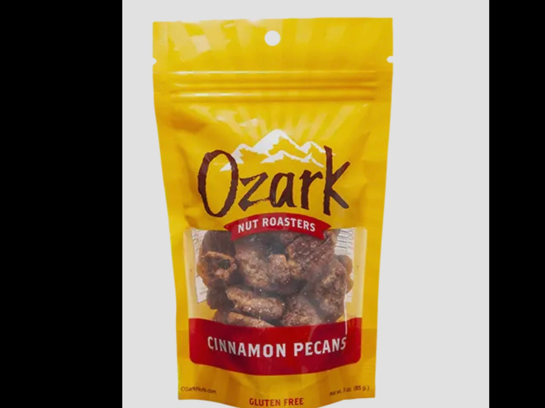 3oz yellow resealable bag of Ozark Nut Roasters Cinnamon Pecans with clear window and gluten free label.