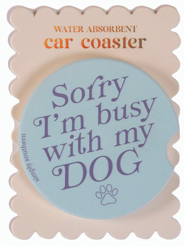 Light blue Simply Southern car coaster with “Sorry I’m busy with my DOG” in purple, paw print. Water-absorbent. One size.