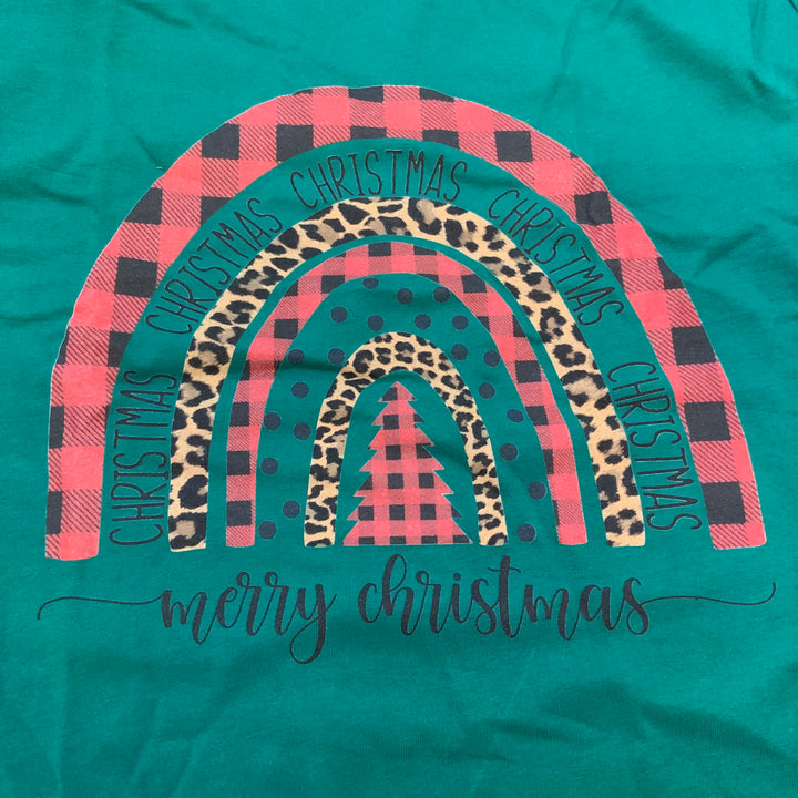 Green Christmas shirt featuring a rainbow arch of red and black buffalo check, cheetah print, and polka dot stripes with “CHRISTMAS” repeated in the arch and “merry christmas” written below.