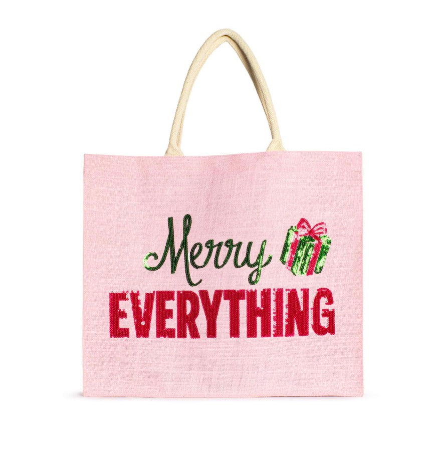 Merry Everything Carryall Tote, a light pink rectangular holiday bag with braided handles, featuring the text “Merry EVERYTHING” in green and red with an illustrated gift box.