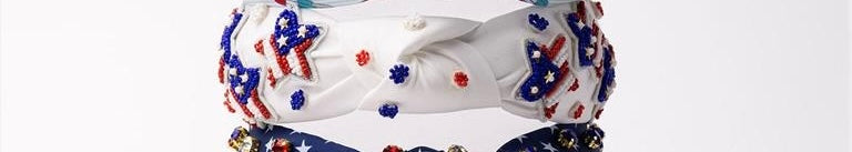 Made in the USA, these Americana Headbands feature intricate patterns of red, blue, and silver beads on a white background. The headbands showcase exceptional craftsmanship and artistic design. Available in one size fits all.