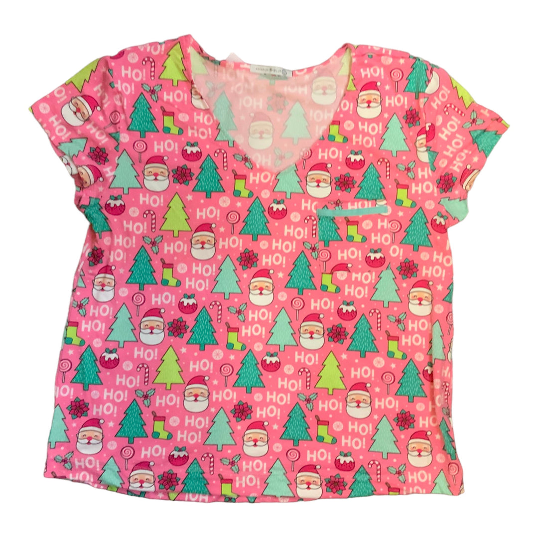 Pink V-neck short-sleeve top with holiday print of Santa, pine trees, candy canes, and “HO!” text. Available in all sizes.