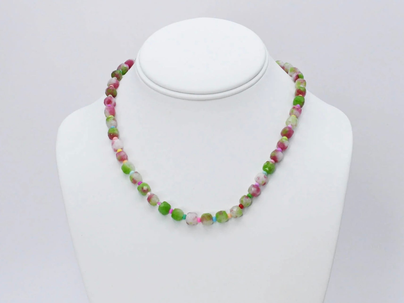 The Camo Girly Necklace by Treasure Jewels has round, faceted beads in green, pink, white, and beige. Sizes available.