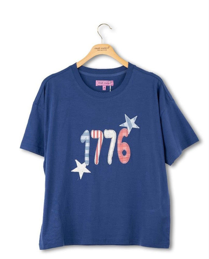 1776 Blue Tee with "1776" in red, white, and blue plus two stars. Soft cotton. Sizes S–XXL.
