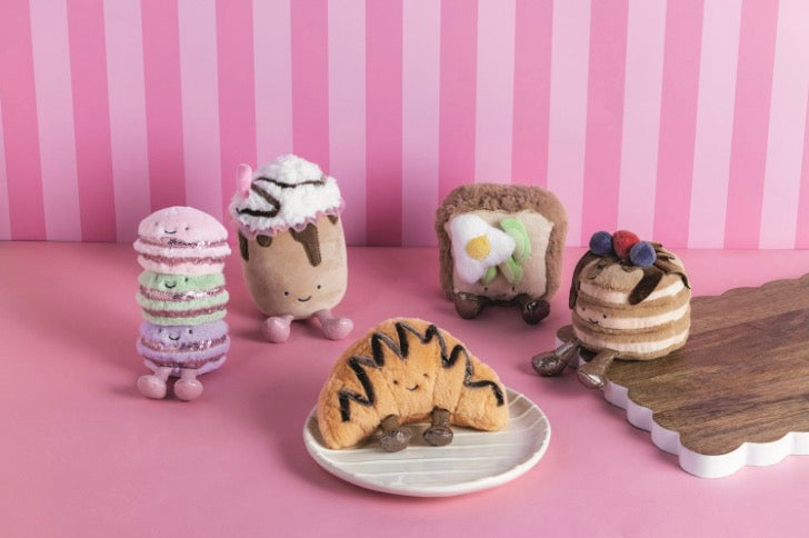 Café Plush Pals: macaron stack, whipped cream dessert, egg toast, berry cake, and croissant. Available in various sizes.