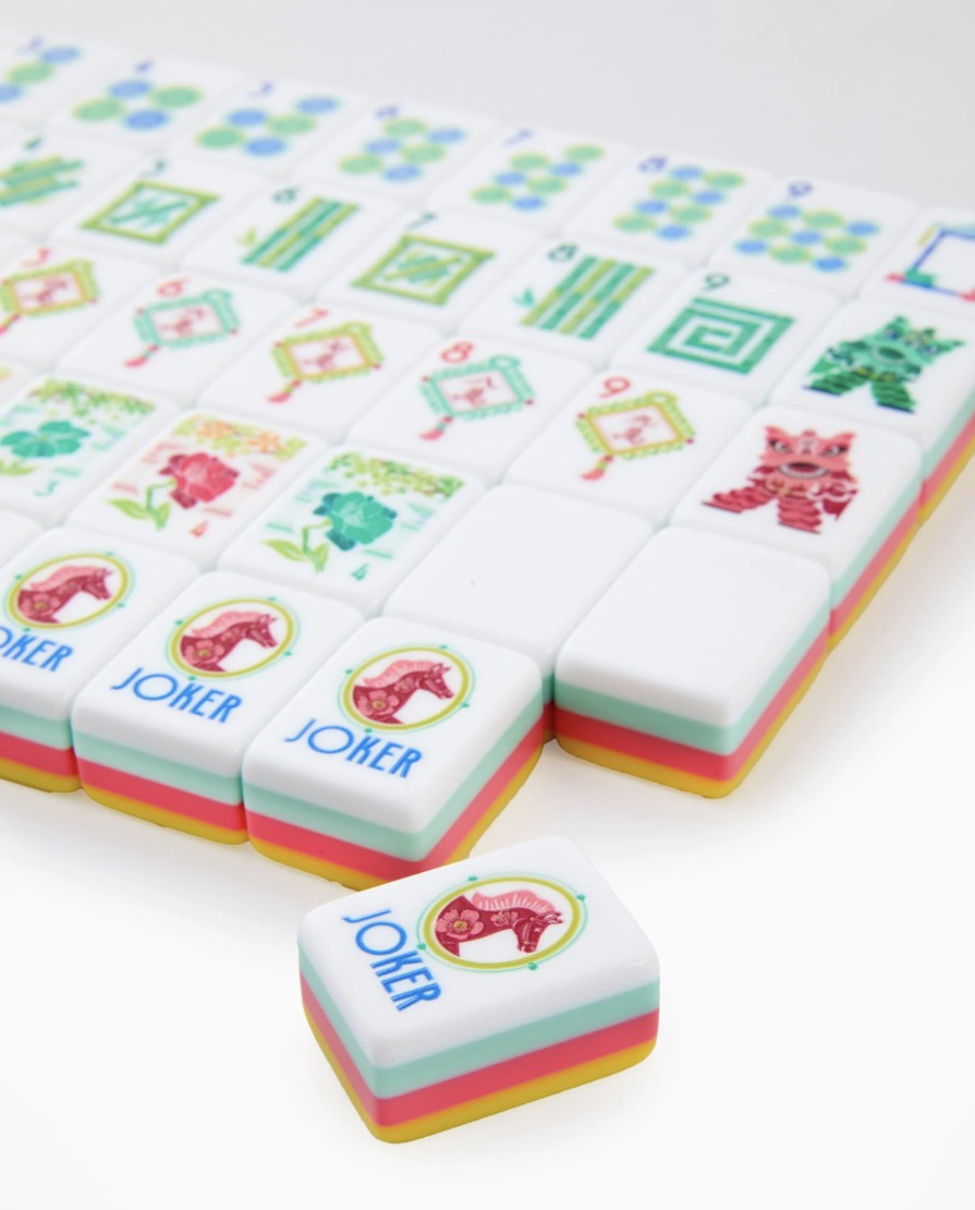 Pippa Mahjong Tiles feature vibrant colors and playful cat and "JOKER" designs, neatly arranged in rows. Available in standard tile size.