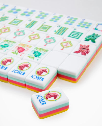 Pippa Mahjong Tiles feature vibrant colors and playful cat and "JOKER" designs, neatly arranged in rows. Available in standard tile size.