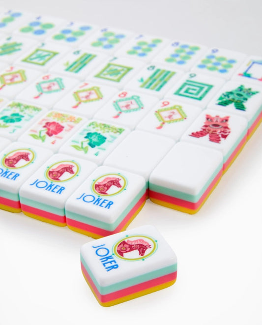 Pippa Mahjong Tiles feature vibrant colors and playful cat and "JOKER" designs, neatly arranged in rows. Available in standard tile size.