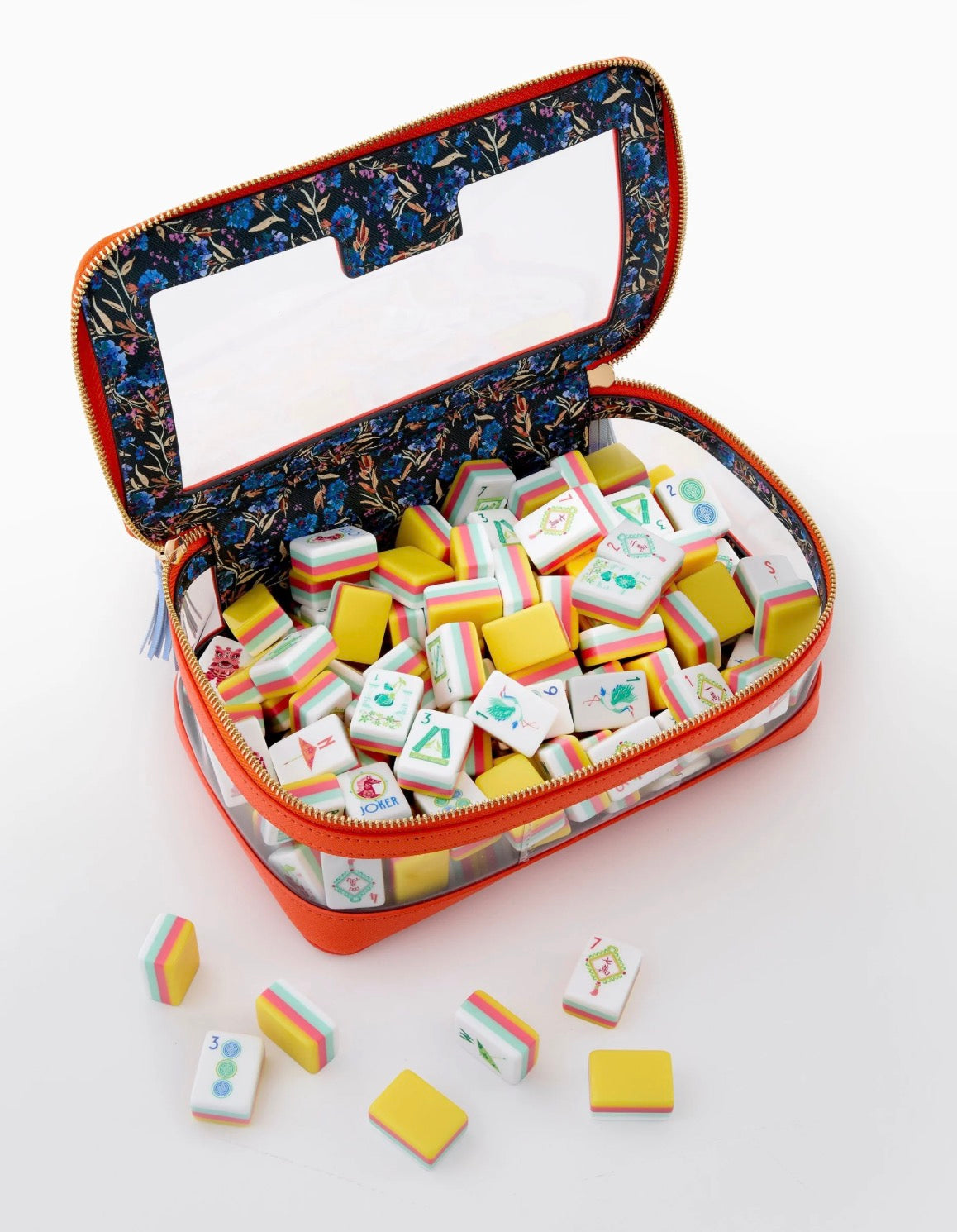 Zippered orange case with floral-print lining containing colorful Pippa Mahjong Tiles. Available in small, medium, and large sizes.
