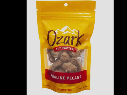 Yellow 3oz resealable bag of Praline Pecans with sweet pecan images and gluten free label.