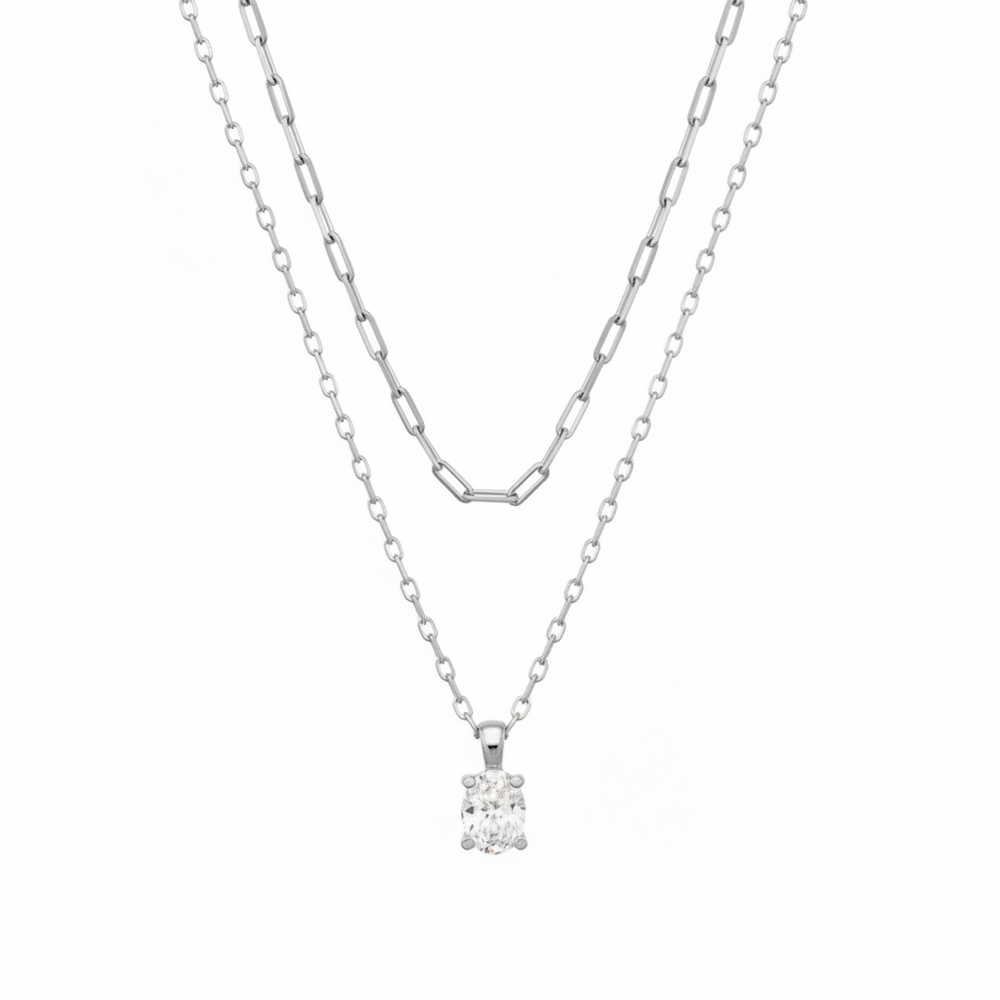 The Cailin Multi Strand Kendra Scott Necklace features two delicate silver strands: one with elongated oval links, the other a simple chain with a round-cut crystal pendant. Available in standard necklace lengths.