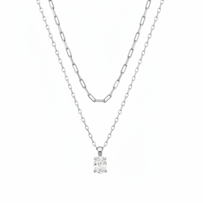 The Cailin Multi Strand Kendra Scott Necklace features two delicate silver strands: one with elongated oval links, the other a simple chain with a round-cut crystal pendant. Available in standard necklace lengths.
