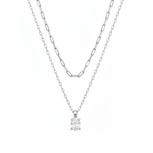 The Cailin Multi Strand Kendra Scott Necklace features two delicate silver strands: one with elongated oval links, the other a simple chain with a round-cut crystal pendant. Available in standard necklace lengths.