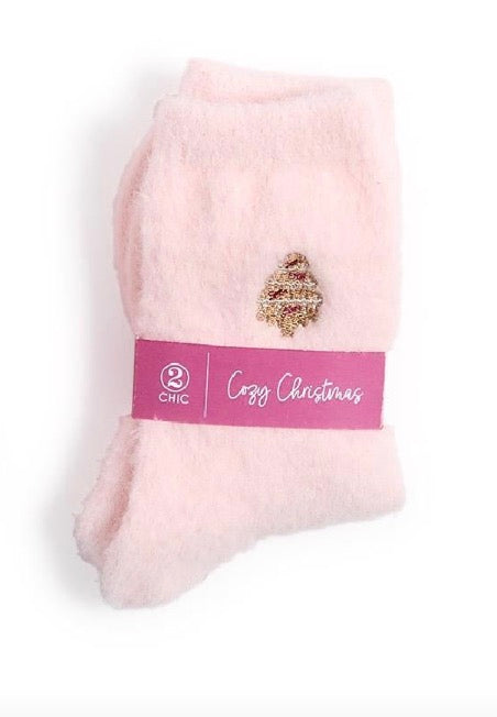 Cozy Holiday Socks: fuzzy pink socks with a Christmas tree emblem, one size.