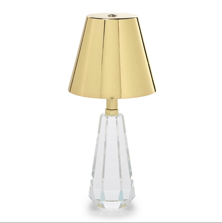 Cordless table lamp with a faceted crystal glass base and metallic gold lampshade; available in small (8″), medium (12″), and large (16″) sizes.