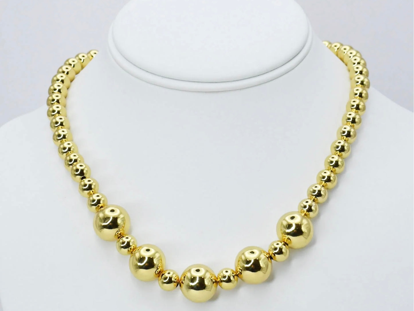 Golden Beads Necklace with shiny gold beads in alternating small and large sizes. Available sizes: small, medium, large.