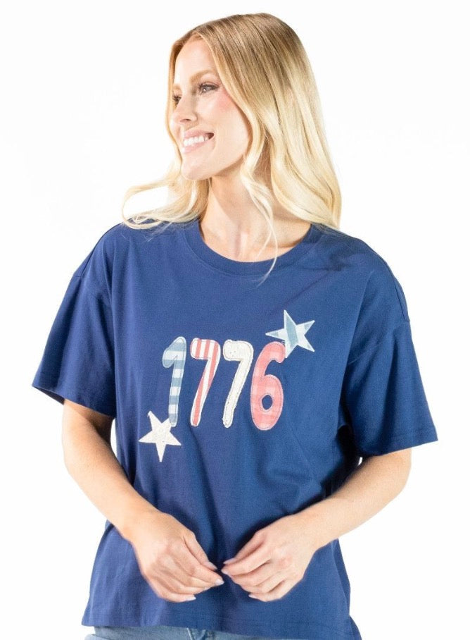 1776 Blue Tee: cotton shirt with "1776" in red, white, and blue, two white stars. Available sizes: S–XXL.