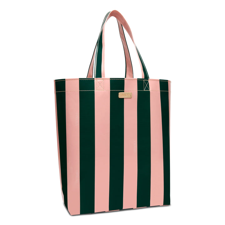The Grab ‘n’ Go Basic, Fern is a utility tote with vertical pink and dark green stripes, two sturdy handles, a small gold label near the top, made from durable ConsuelaCloth. Available in basic size.
