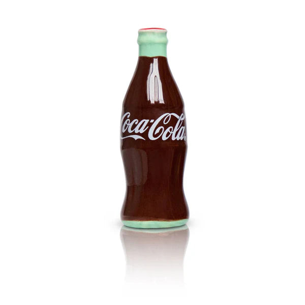 Nora Fleming Minis ceramic Coca-Cola bottle sculpture with white logo, brown body, green accents. Available in mini size.