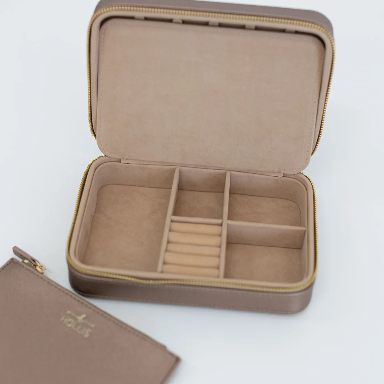 The Jewelry Organizer | Hollis is a brown, rectangular travel case with a beige interior, featuring divided compartments and ring slots. Available in multiple sizes.