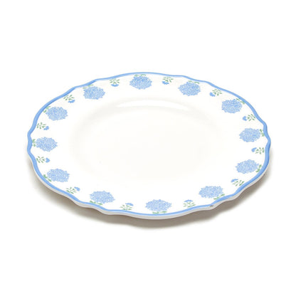 White melamine plate with blue floral pattern, scalloped edge, and light blue rim. Dishwasher safe. Available in 11" size.