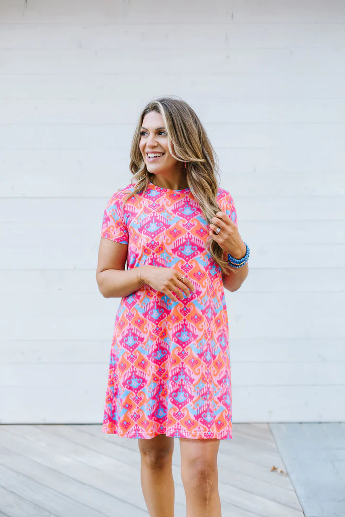 The Augusta Afternoon Tea Dress +UPF50 is available in a bright pink and blue pattern. Sizes available include small, medium, large, and extra-large.