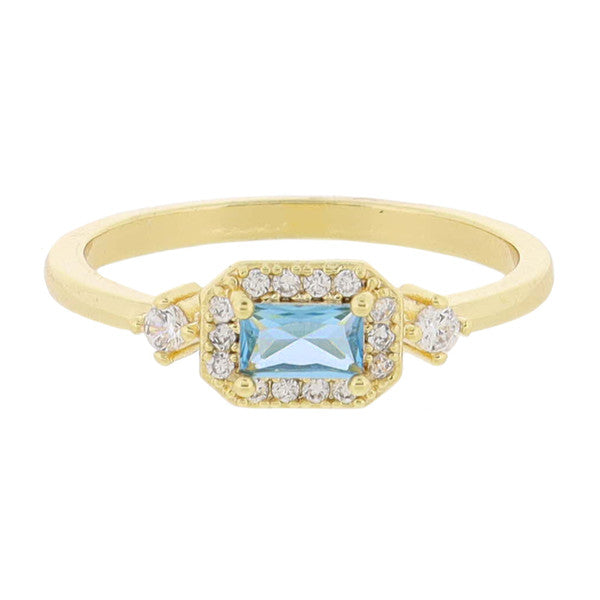 This is an 18K Gold Plated Ring featuring a central rectangular light blue gemstone and mini crystals around the edges. The same crystals are also set into the band for added sparkle. Sizes available are 5, 6, 7, 8 and 9.