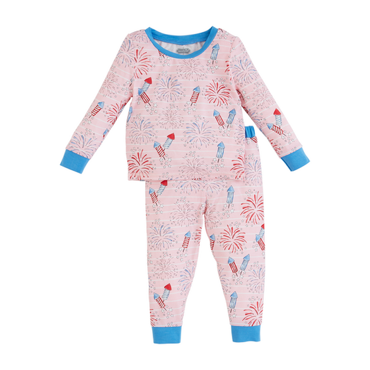 Children's long-sleeved Girl Firework Glow Pjs in pink with a playful pattern of rockets and fireworks, featuring glow-in-the-dark bamboo knit fabric, blue cuffs and neckline, isolated on a white background.