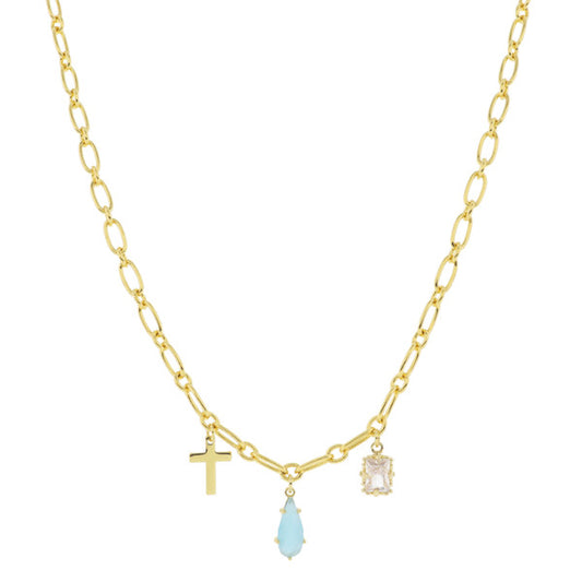 This 18K gold plated necklace features a beautiful dangling cross, complemented by an aqua teardrop gem and an emerald crystal. The simplistic design is showcased on a plain white background. The necklace comes in one standard size, suitable for most individuals.