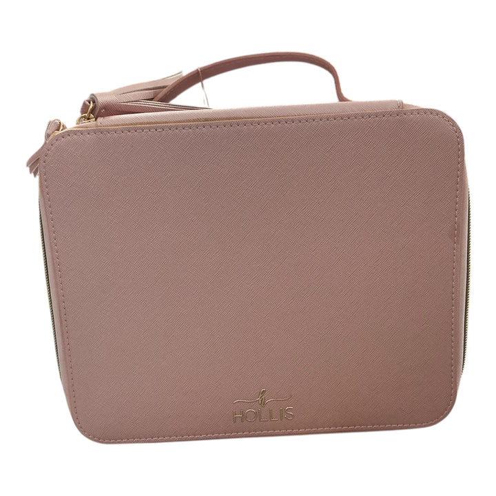 Blush pink rectangular zippered makeup bag with handle, gold "HOLLIS" logo, tassel zipper; available in multiple sizes.